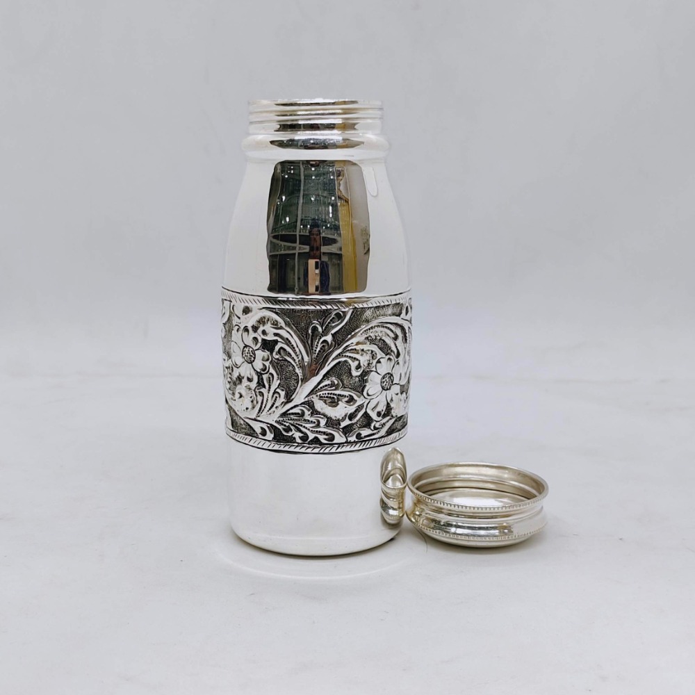 Hallmarked silver bottle in fine antique centre floral design carving