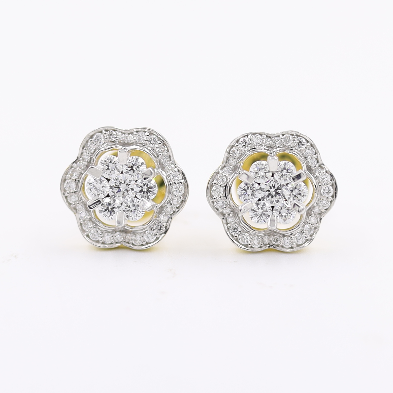 14kt Ethereal Floral Earrings topped with a round pressure-set diamond.