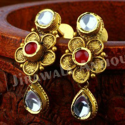 Antique gold jadtar flower shape earring with ruby and white kundan work.